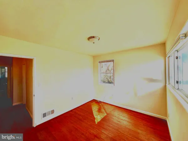 a view of room with window and wooden floor