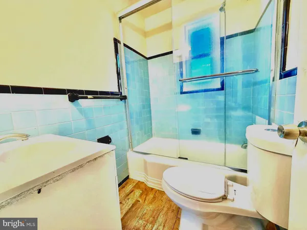 a bathroom with a sink a toilet and tub