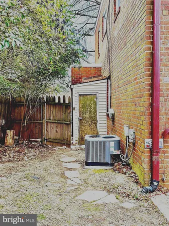 a view of house with backyard and seating area