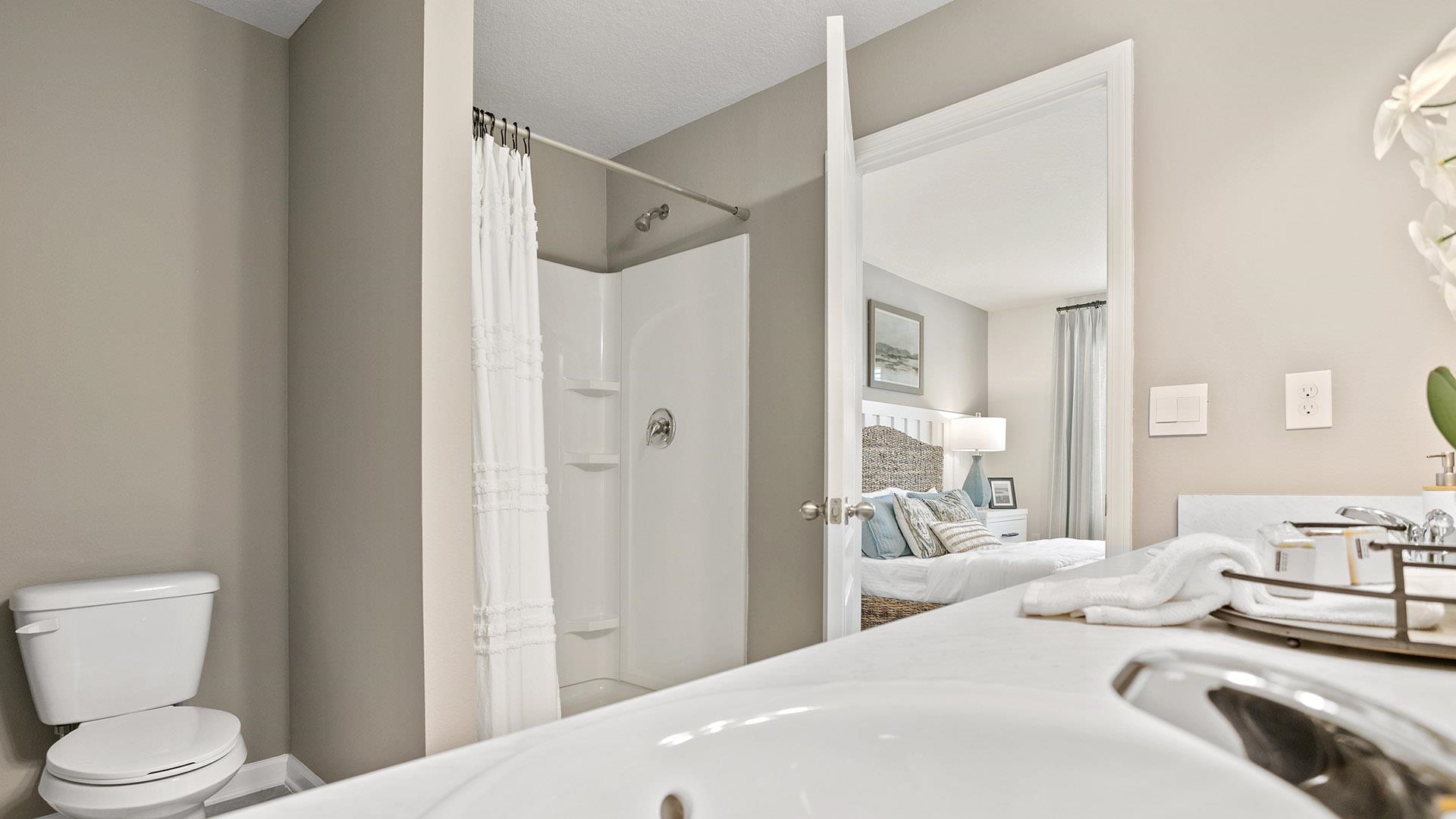 327 Redbud Road Palm Coast, FL 32137 - Photo 15 of 33 a bedroom with a bed and a view of bathroom