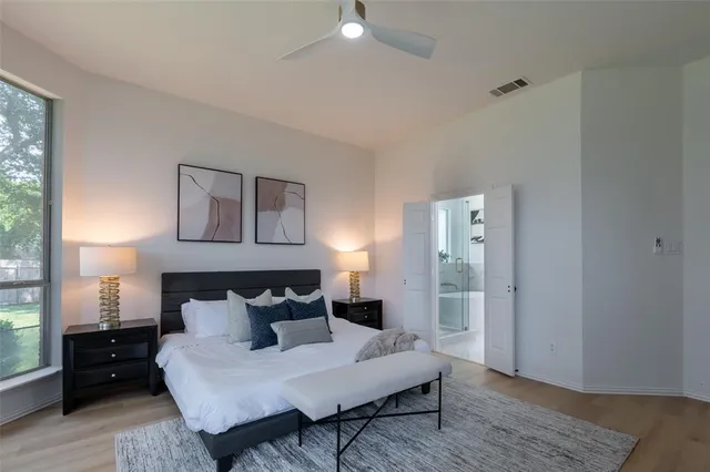 a bed room with a bed and a night stand