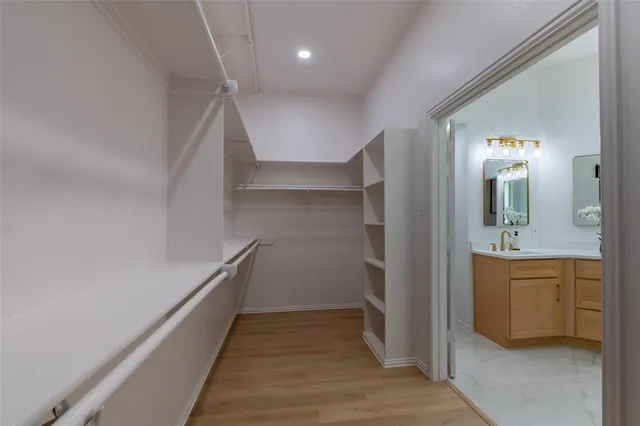 a view of a hallway with a sink and a refrigerator