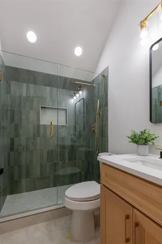 a bathroom with a shower a toilet and a sink