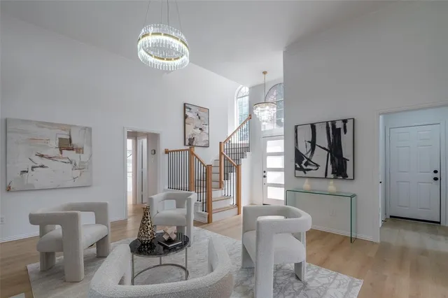 a living room with furniture and a chandelier
