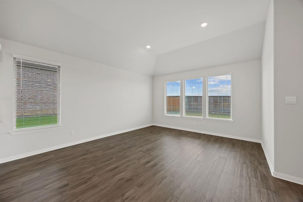 1502 Red Clover Avenue Van Alstyne, TX 75495 - Photo 11 of 27 a view of an empty room with wooden floor and a window