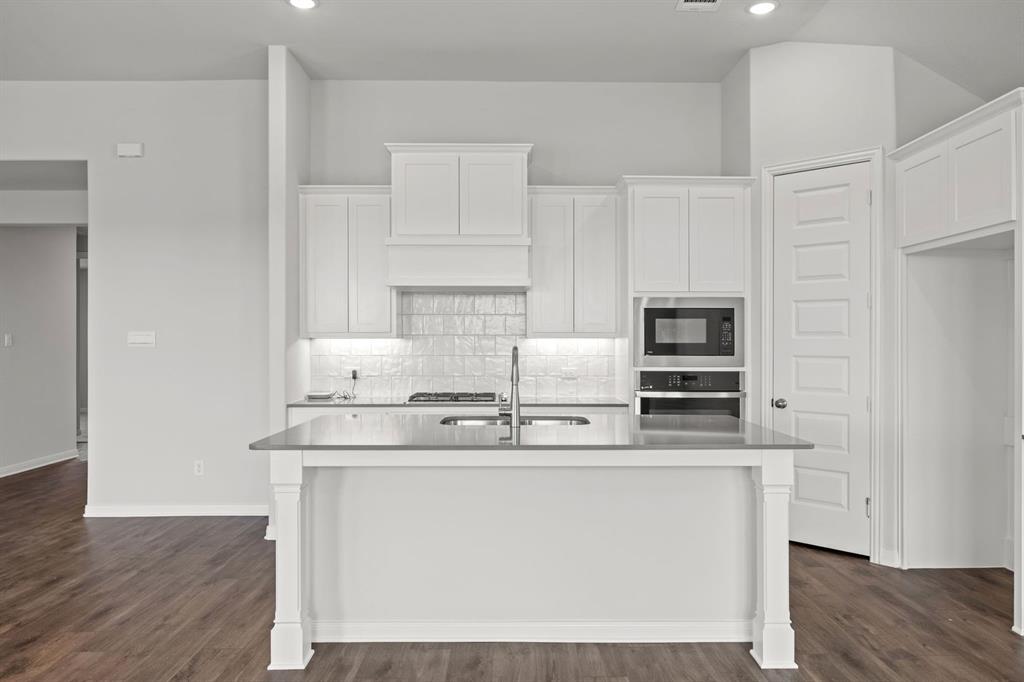 1502 Red Clover Avenue Van Alstyne, TX 75495 - Photo 3 of 27 a kitchen with kitchen island stainless steel appliances a sink and stove