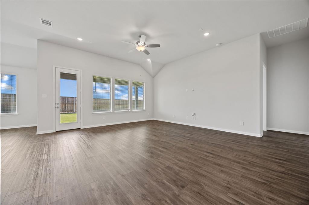 1502 Red Clover Avenue Van Alstyne, TX 75495 - Photo 6 of 27 an empty room with wooden floor chandelier and windows