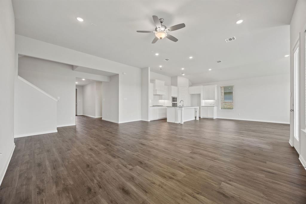 1502 Red Clover Avenue Van Alstyne, TX 75495 - Photo 7 of 27 a view of kitchen and hall with wooden floor