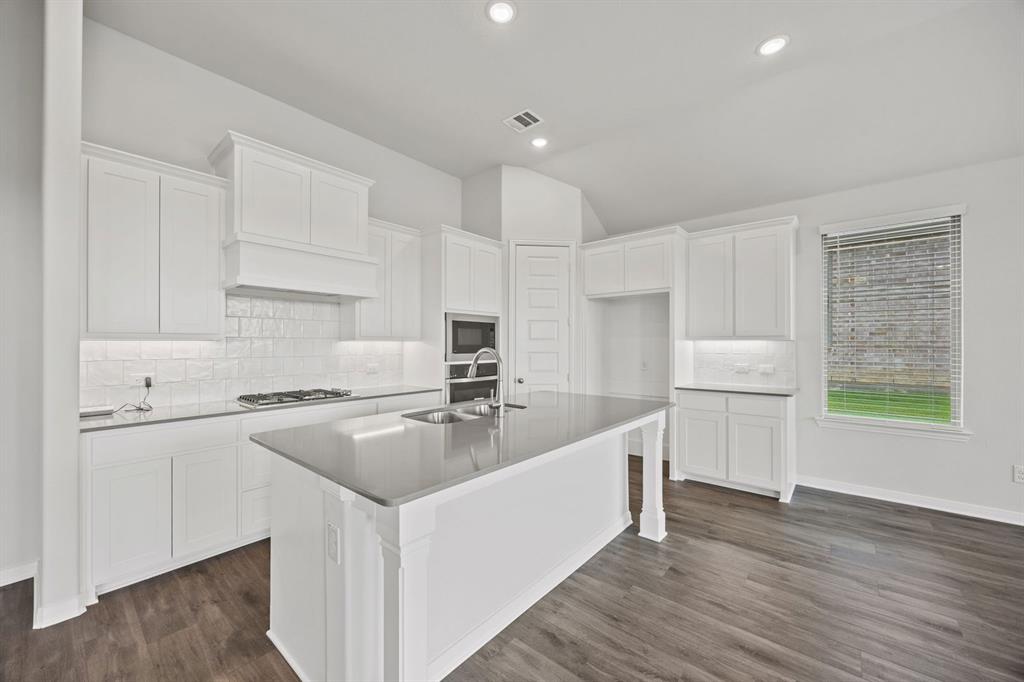 1502 Red Clover Avenue Van Alstyne, TX 75495 - Photo 10 of 27 a kitchen with a stove a sink and a refrigerator