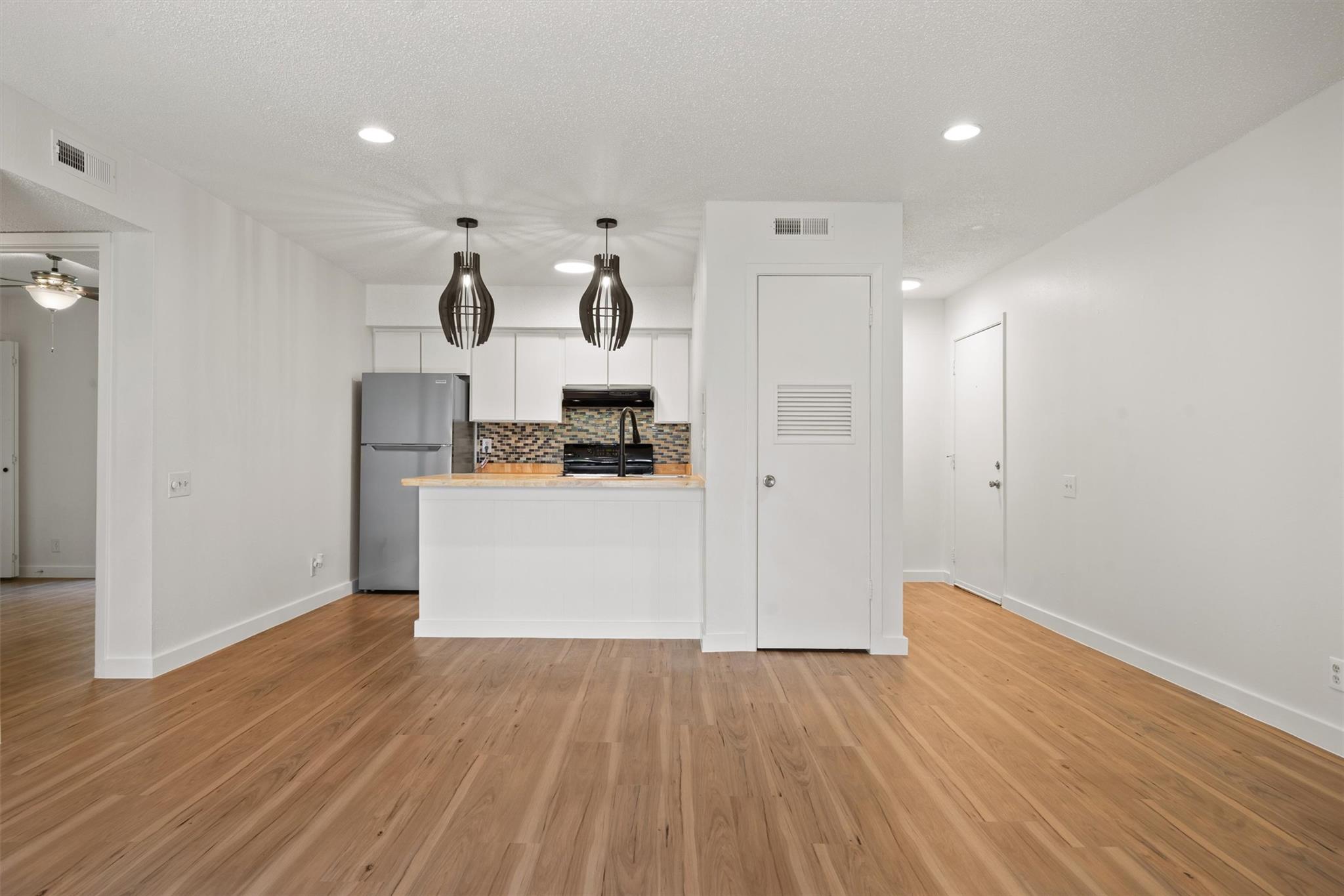 620 South 1st Street, Unit 116 Austin, TX 78704 - Photo 1 of 19 a view of kitchen with wooden floor