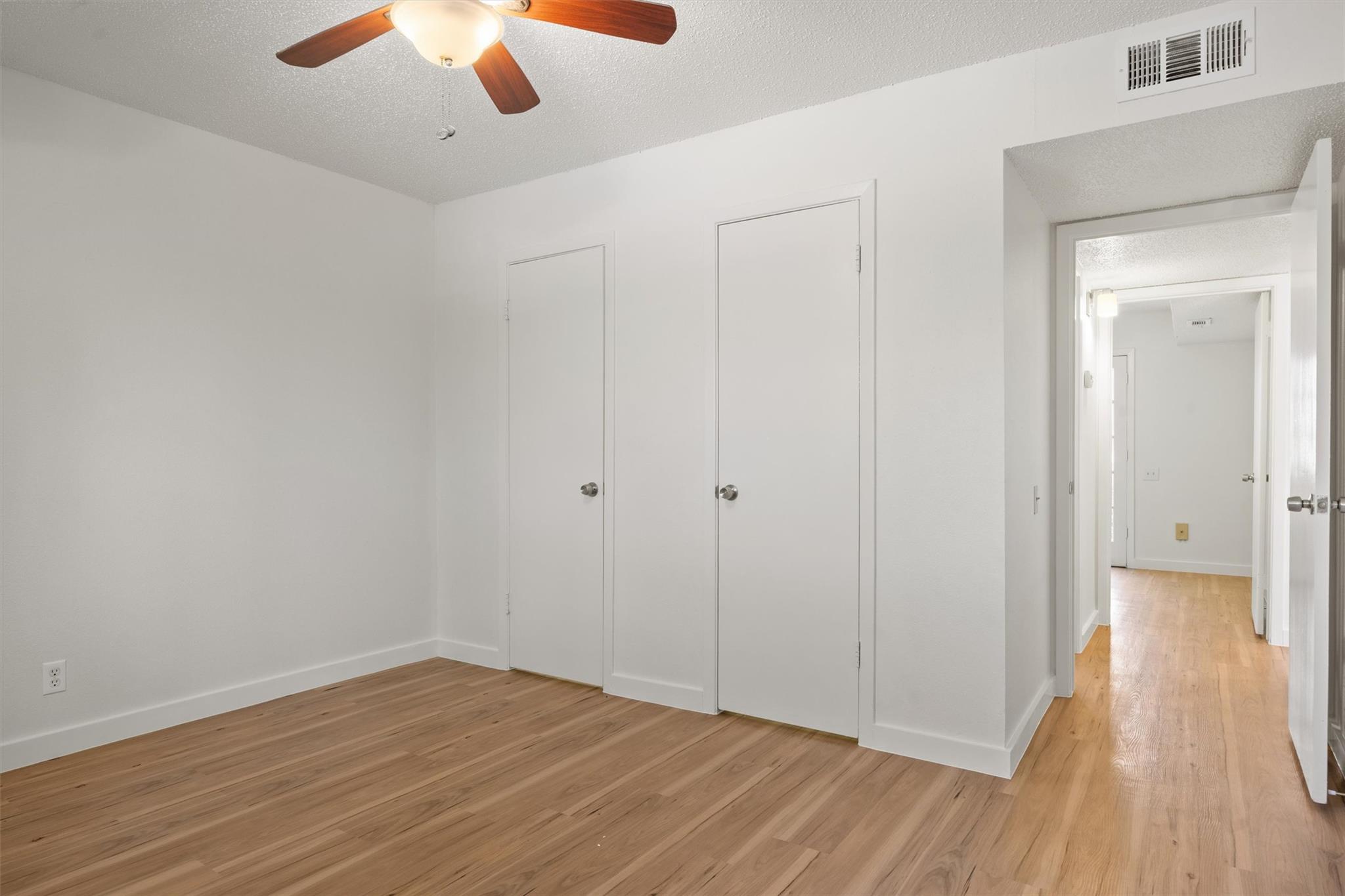 620 South 1st Street, Unit 116 Austin, TX 78704 - Photo 11 of 19 a view of an empty room with wooden floor