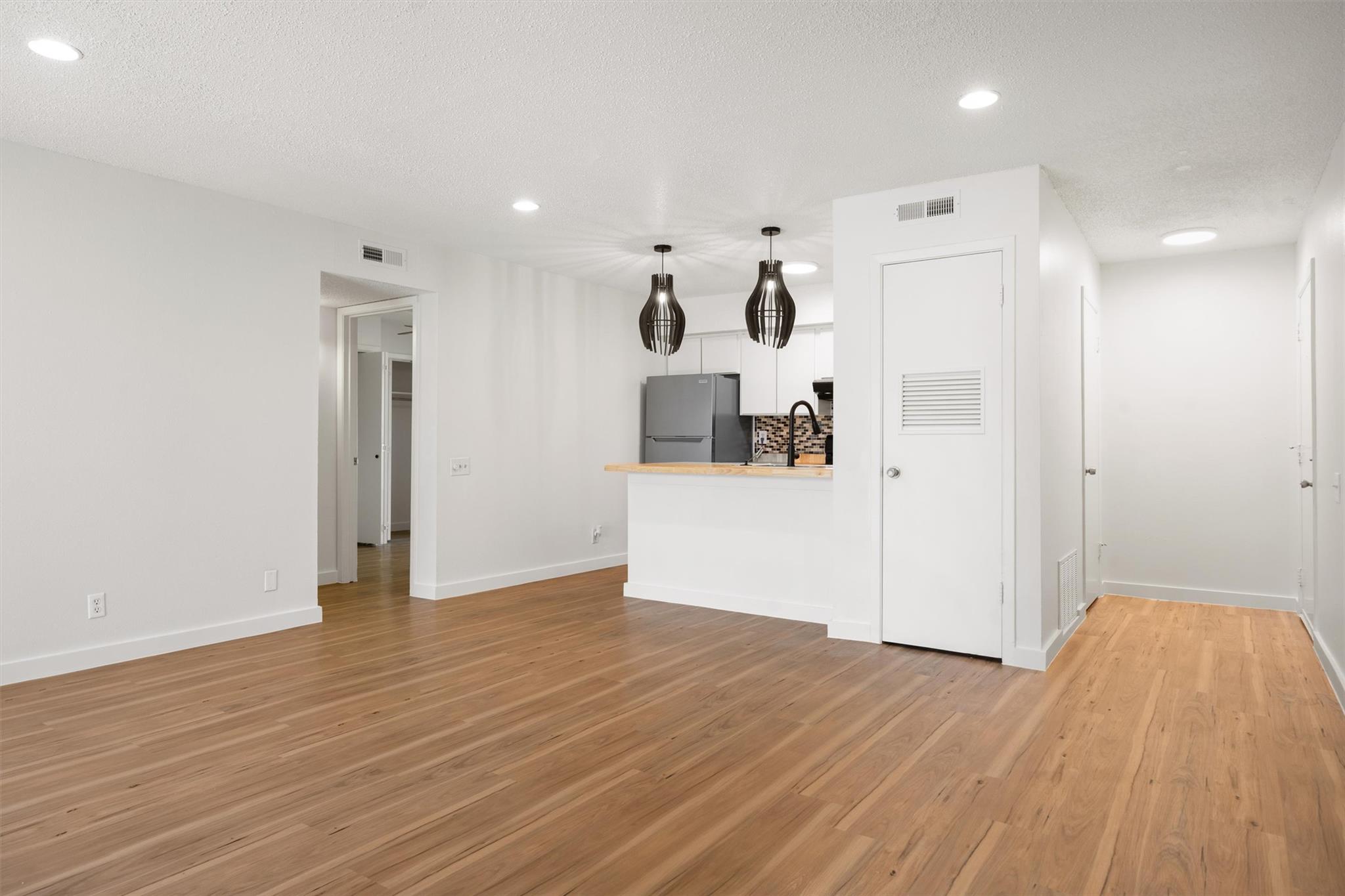 620 South 1st Street, Unit 116 Austin, TX 78704 - Photo 2 of 19 a view of a kitchen with wooden floor
