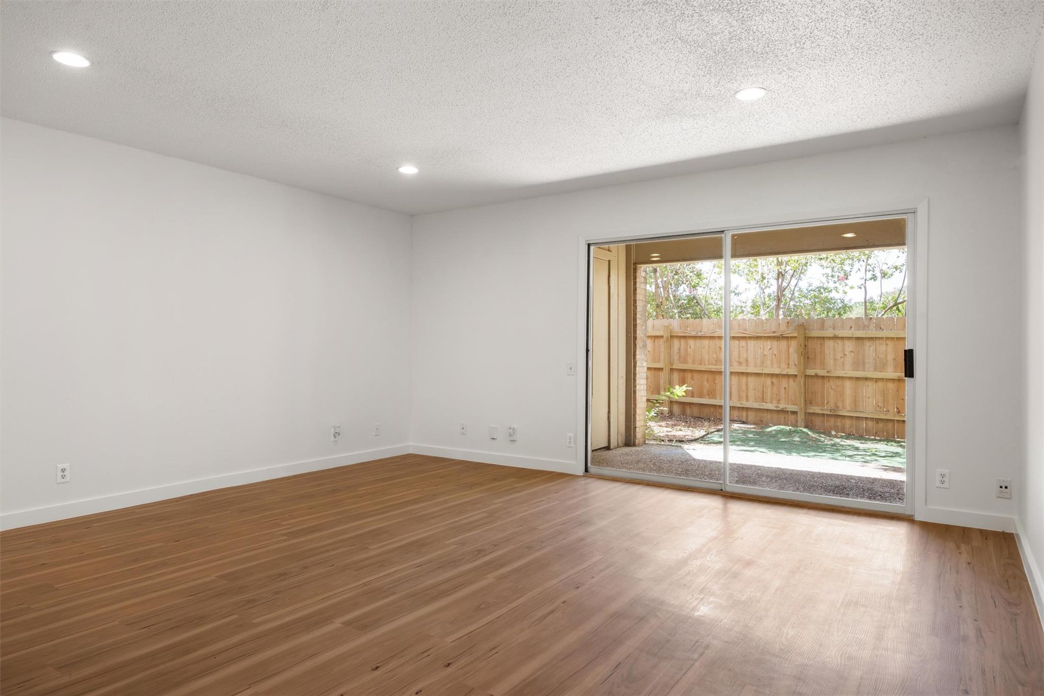620 South 1st Street, Unit 116 Austin, TX 78704 - Photo 3 of 19 wooden floor in an empty room with a window