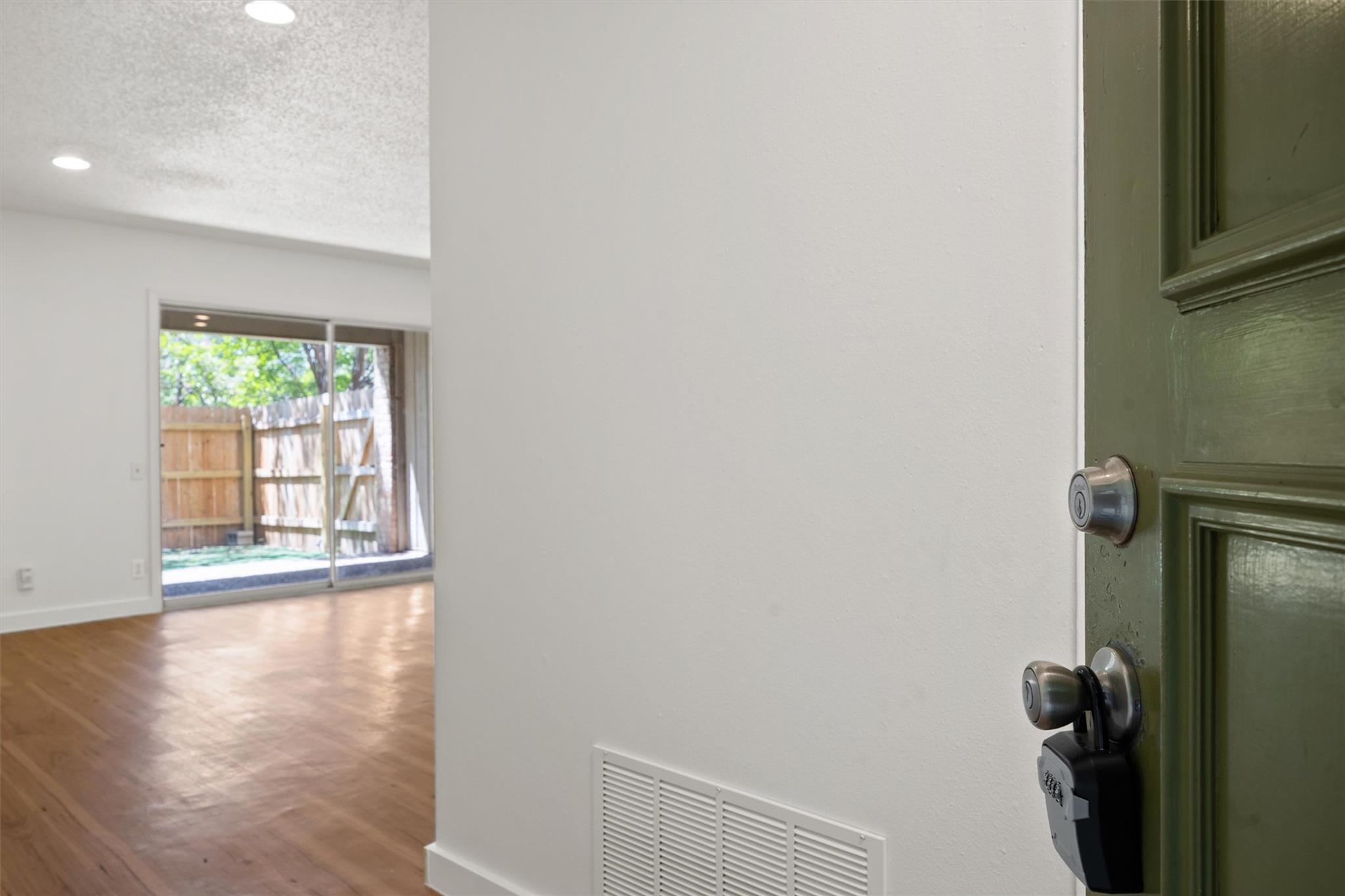 620 South 1st Street, Unit 116 Austin, TX 78704 - Photo 9 of 19 a view of a room with wooden floor and a window