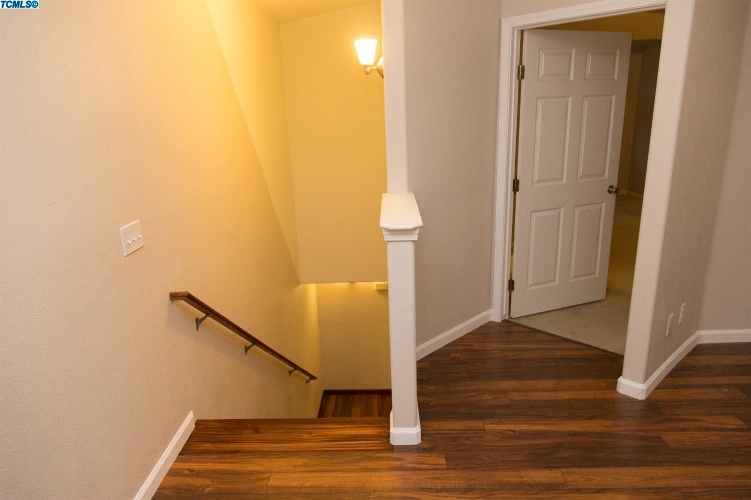 148 South Filbert Road Exeter, CA 93221 - Photo 12 of 23 a view of a hallway with wooden floor and staircase