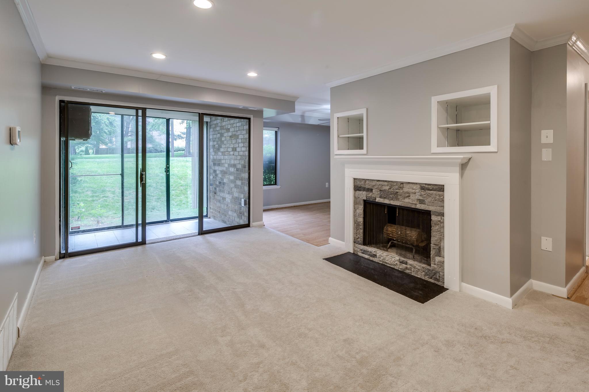 10547 Twin Rivers Road, Unit B1 Columbia, MD 21044 - Photo 11 of 30 Living Room- Wood Burning FP with Stonework
