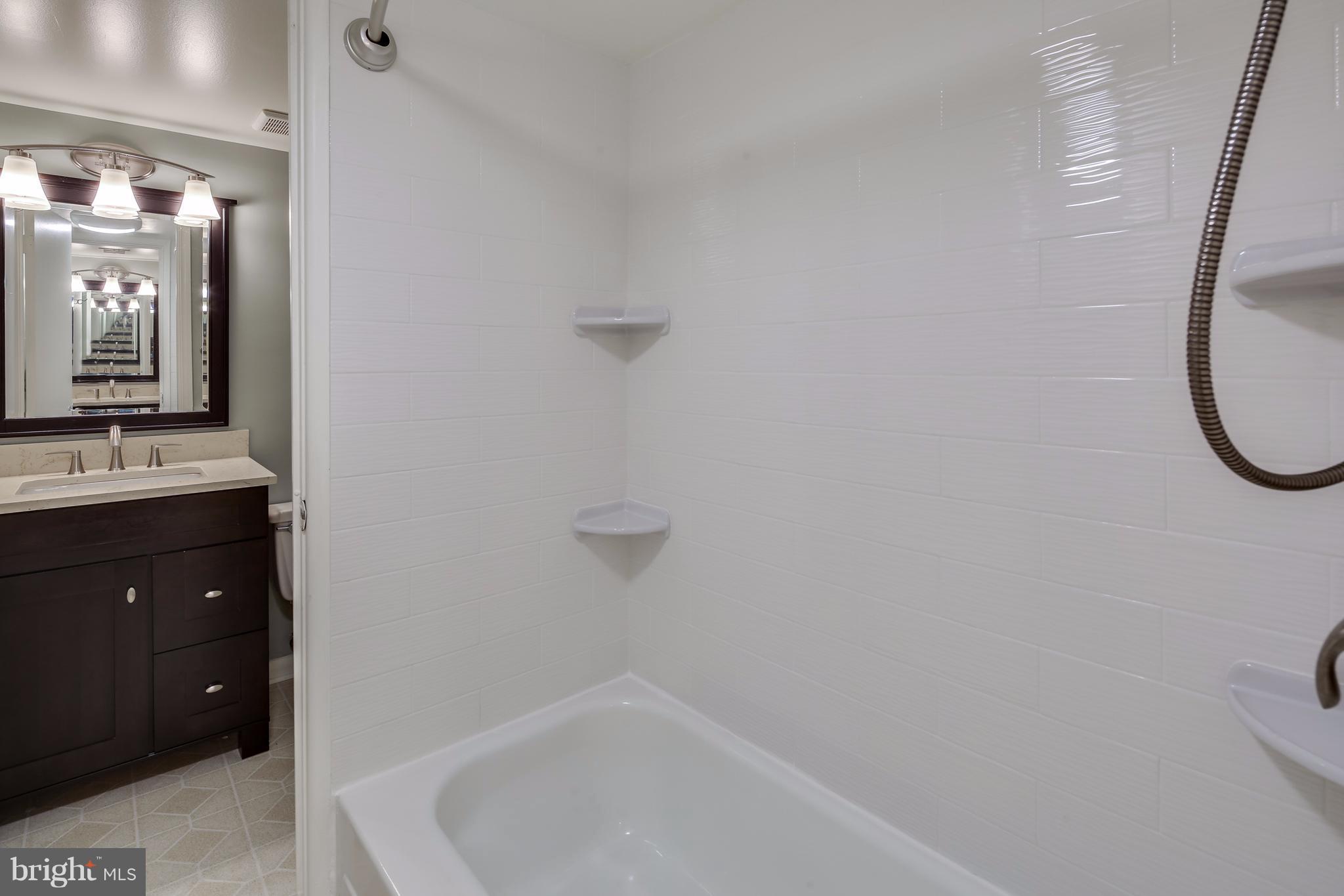 10547 Twin Rivers Road, Unit B1 Columbia, MD 21044 - Photo 26 of 30 Ceramic Shower w/ Access From Hall Half Bath