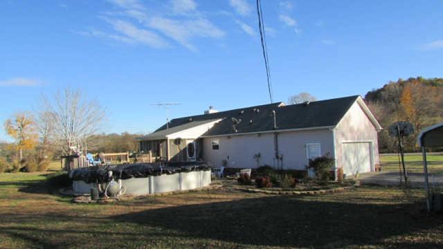 3320 Booker Ridge Road Mount Pleasant, TN 38474 - Photo 2 of 13 SCREENED IN BACK PORCH WITH LARGE SECTIONAL DECK AND POOL