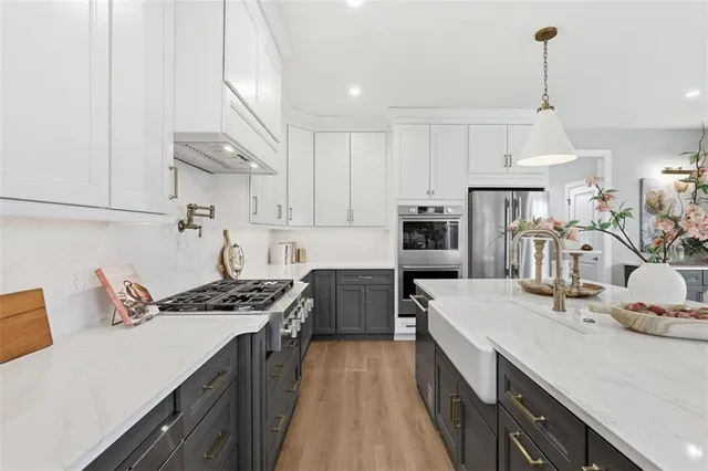 a kitchen with granite countertop a sink stove and cabinets
