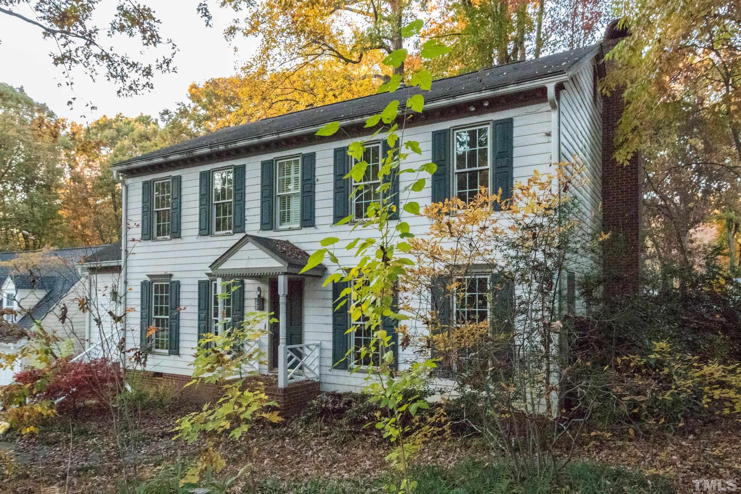 a front view of a house with yard and green space