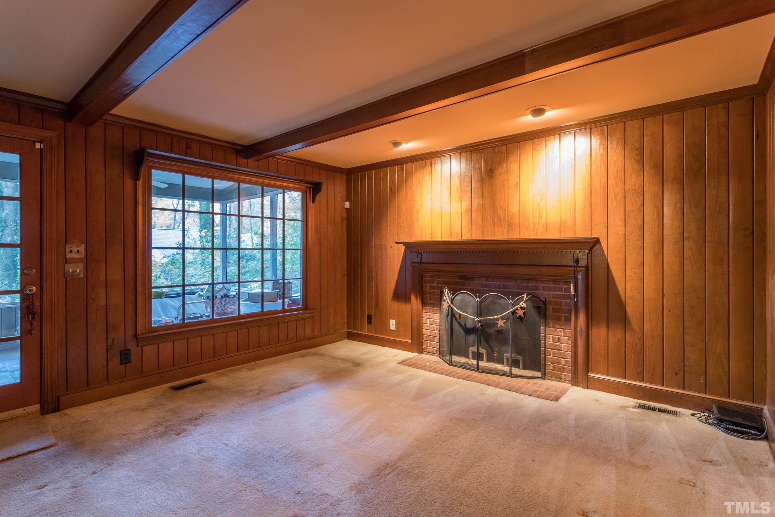 704 Blenheim Drive Raleigh, NC 27612 - Photo 11 of 23 an empty room with windows and fireplace