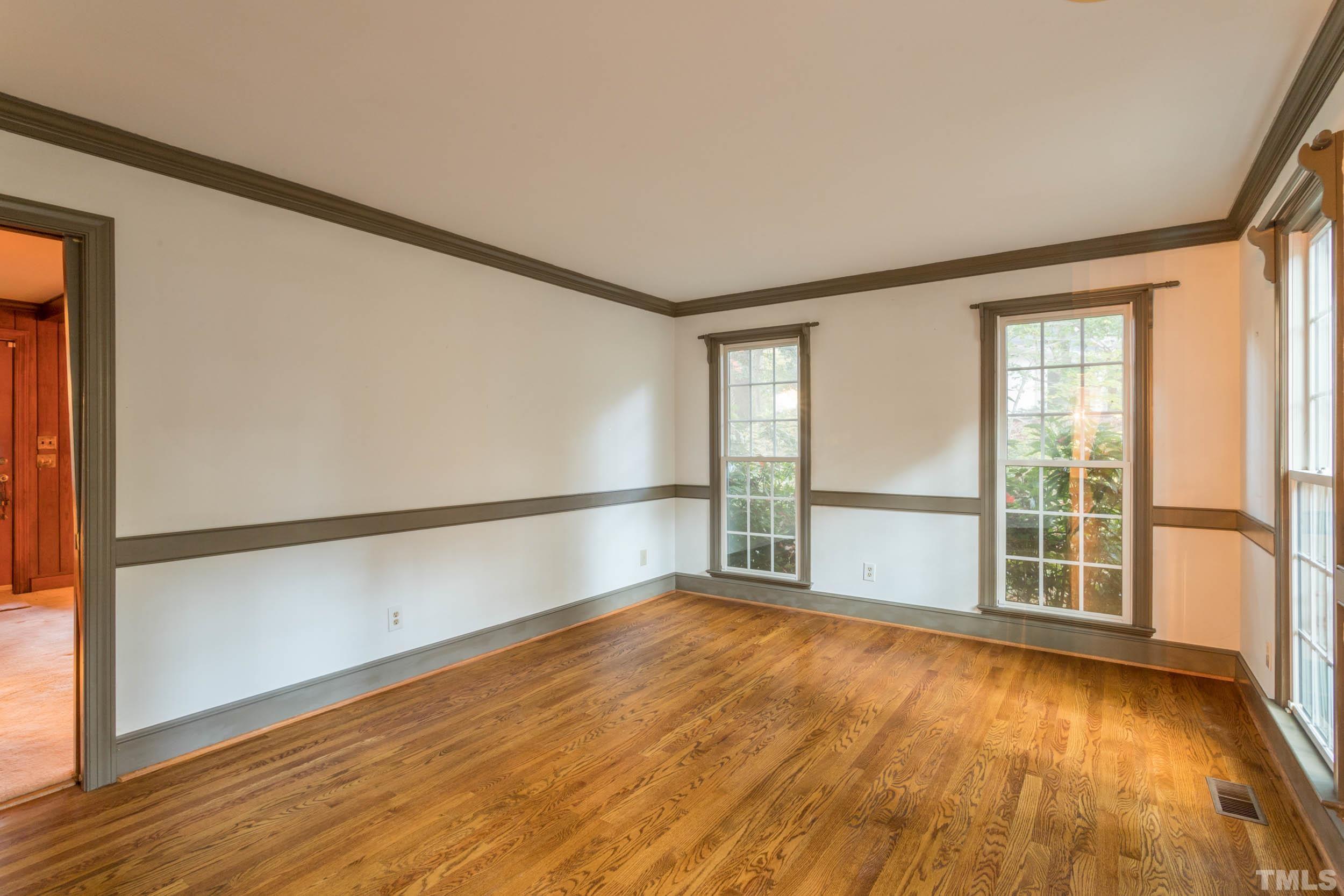 704 Blenheim Drive Raleigh, NC 27612 - Photo 13 of 23 an empty room with wooden floor and windows
