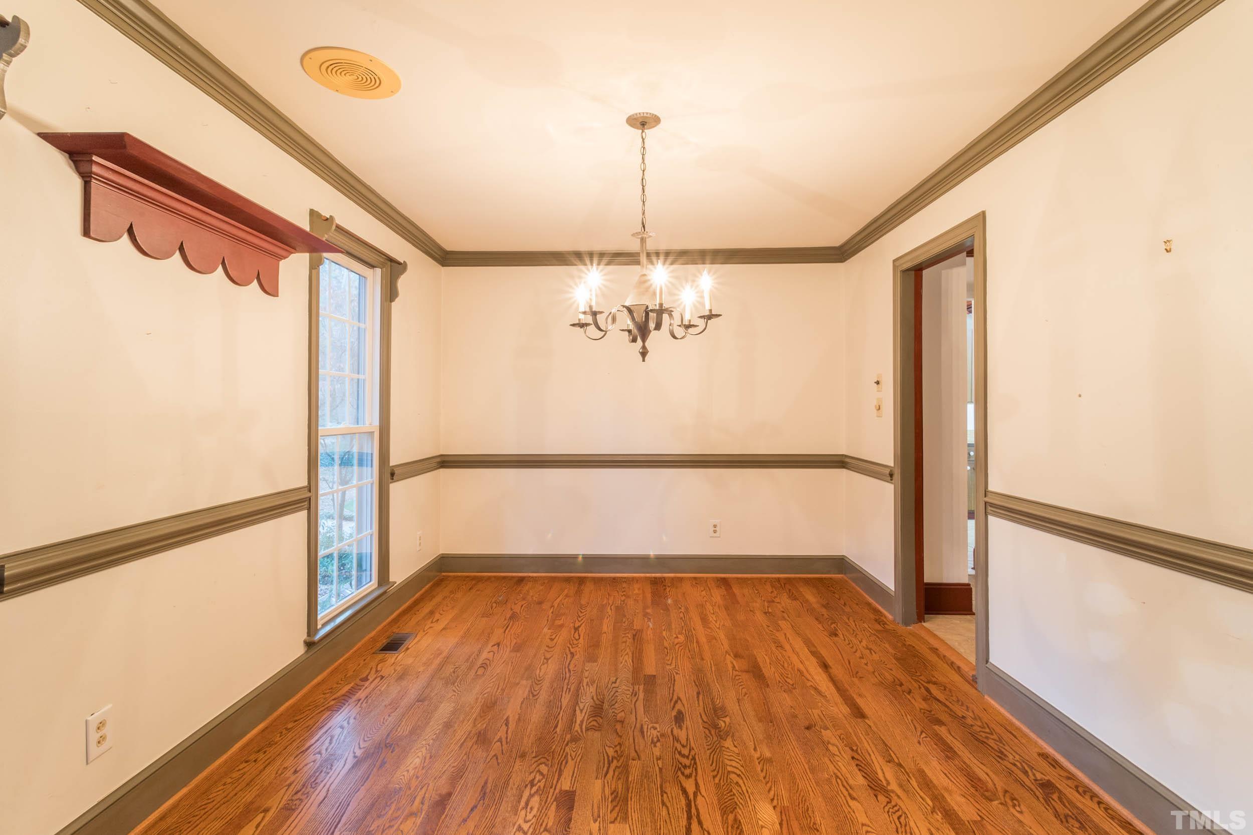 704 Blenheim Drive Raleigh, NC 27612 - Photo 14 of 23 a view of a room with wooden floor fan and window