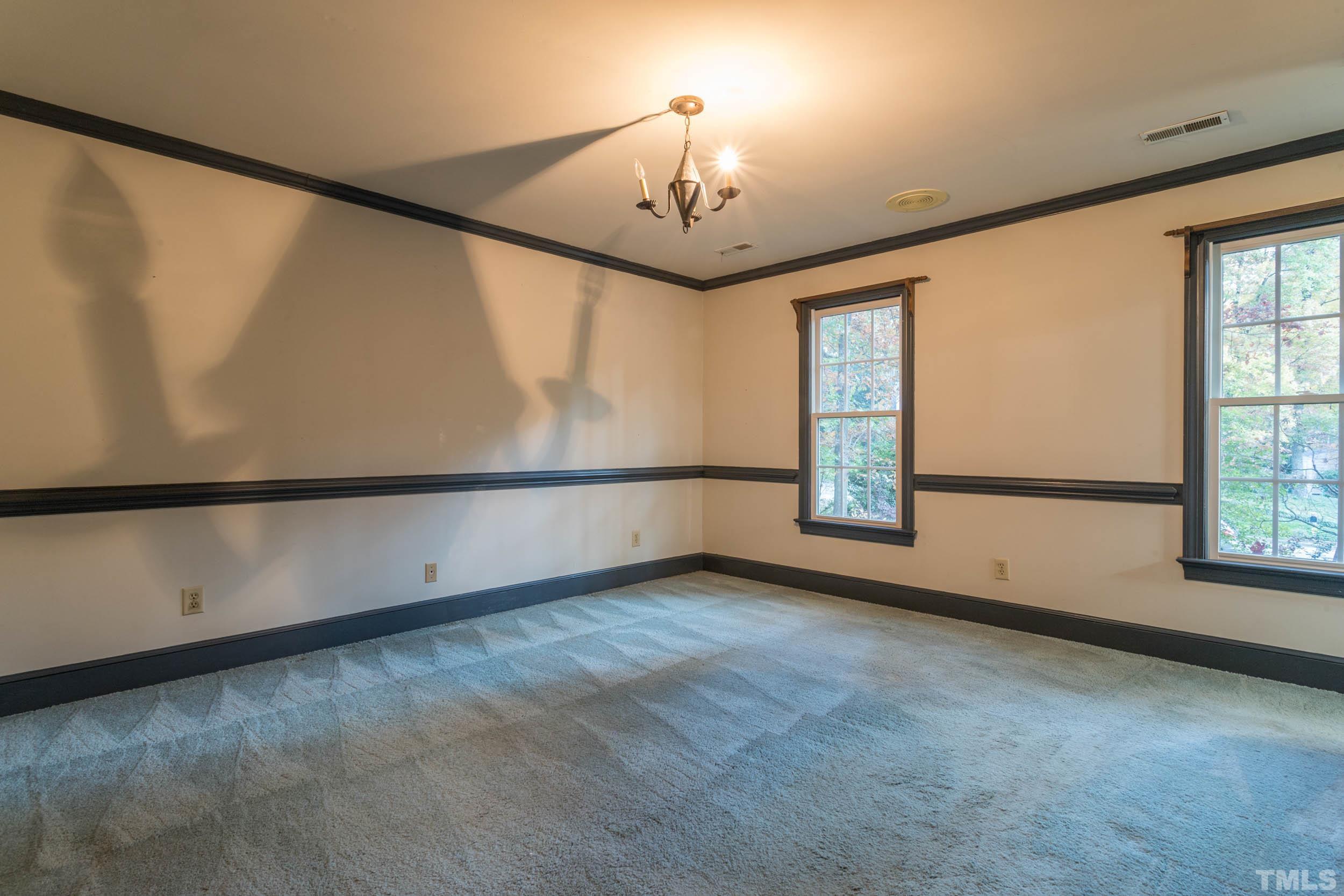 704 Blenheim Drive Raleigh, NC 27612 - Photo 21 of 23 an empty room with windows