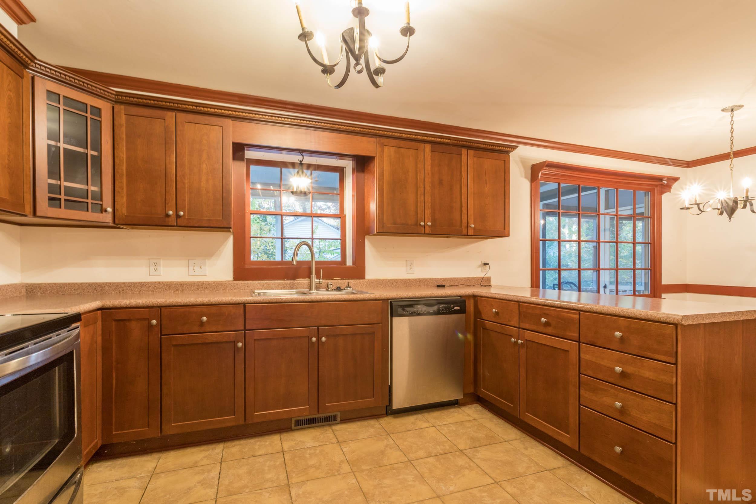 704 Blenheim Drive Raleigh, NC 27612 - Photo 6 of 23 a kitchen with a sink stove and microwave