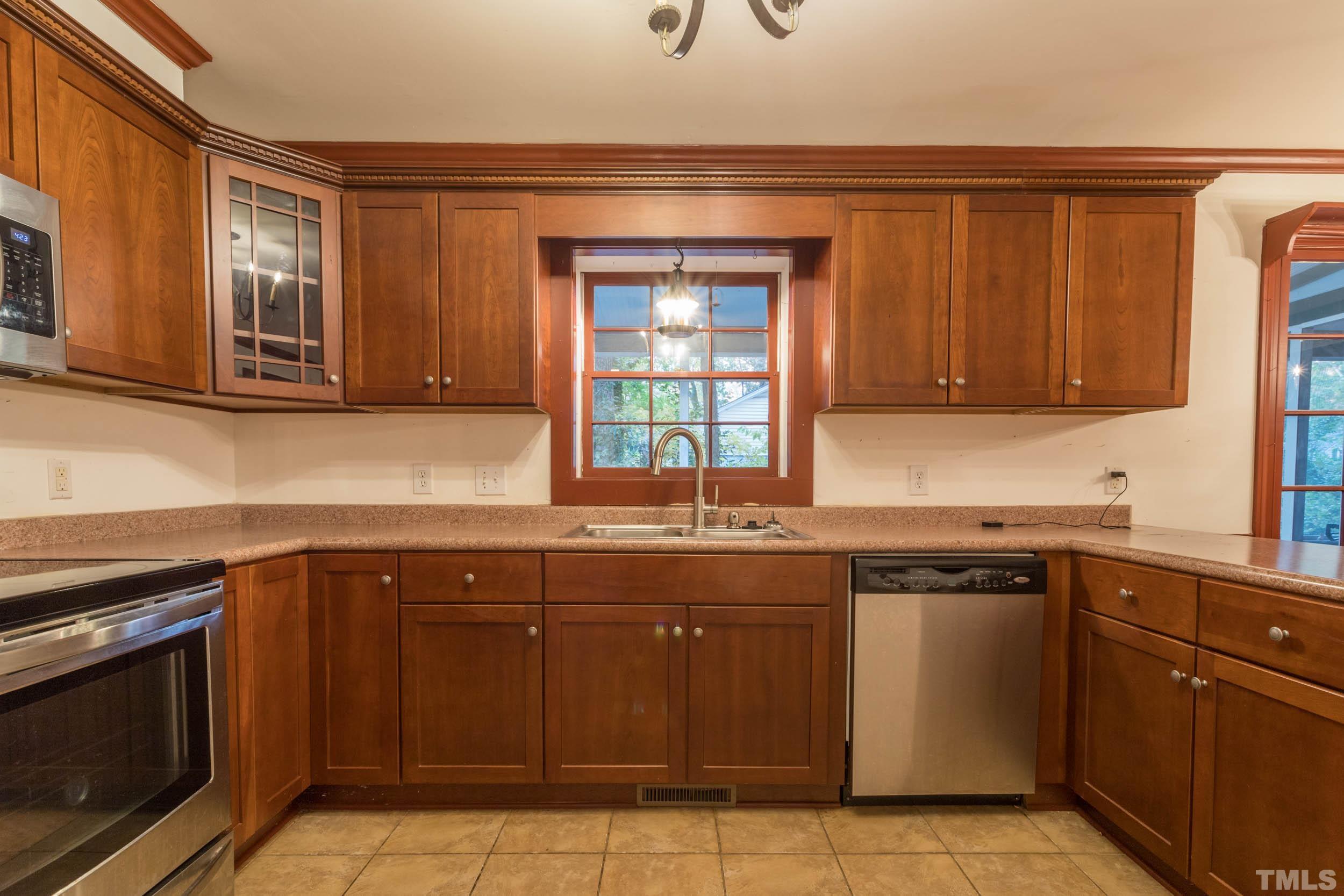 704 Blenheim Drive Raleigh, NC 27612 - Photo 7 of 23 a kitchen with a sink stove top oven and cabinets
