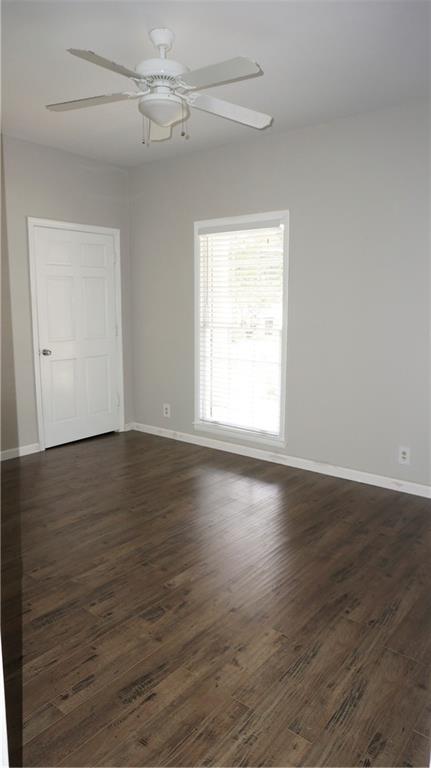 3763 Ashford Dunwoody Road Northeast Brookhaven, GA 30319 - Photo 11 of 14 an empty room with wooden floor fan and windows
