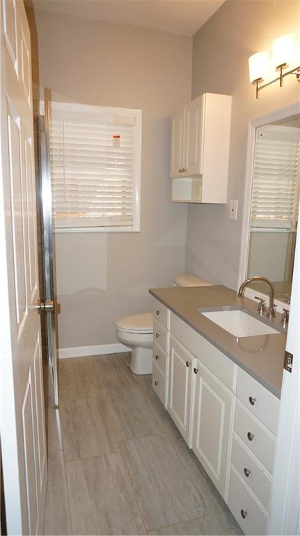 3763 Ashford Dunwoody Road Northeast Brookhaven, GA 30319 - Photo 12 of 14 a bathroom with a granite countertop sink toilet and mirror