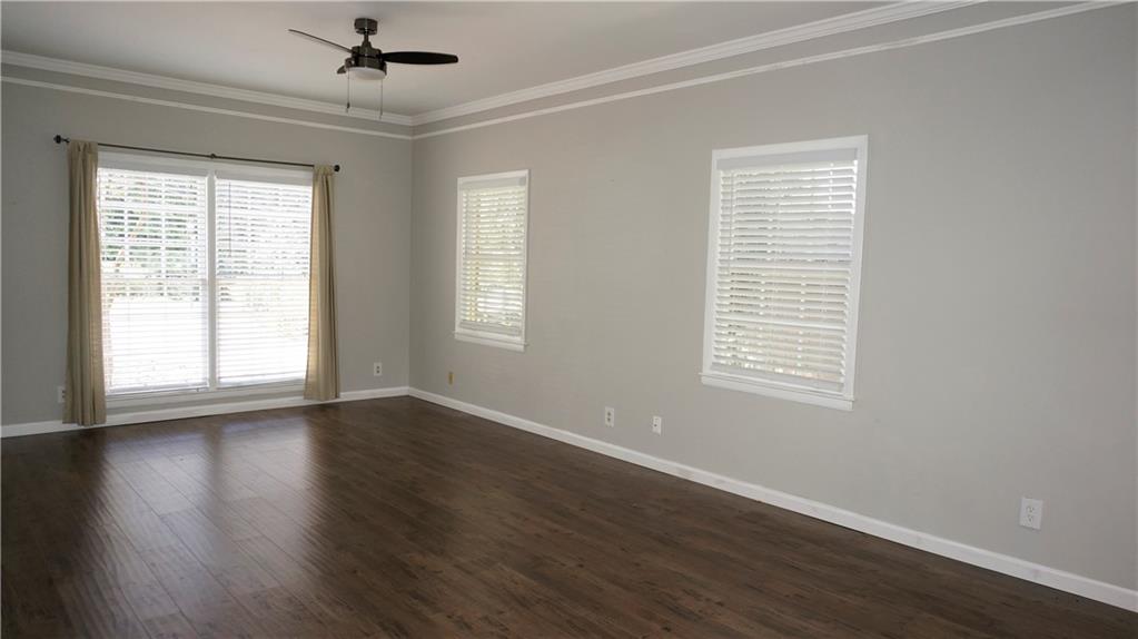 3763 Ashford Dunwoody Road Northeast Brookhaven, GA 30319 - Photo 4 of 14 a view of an empty room with wooden floor and a window