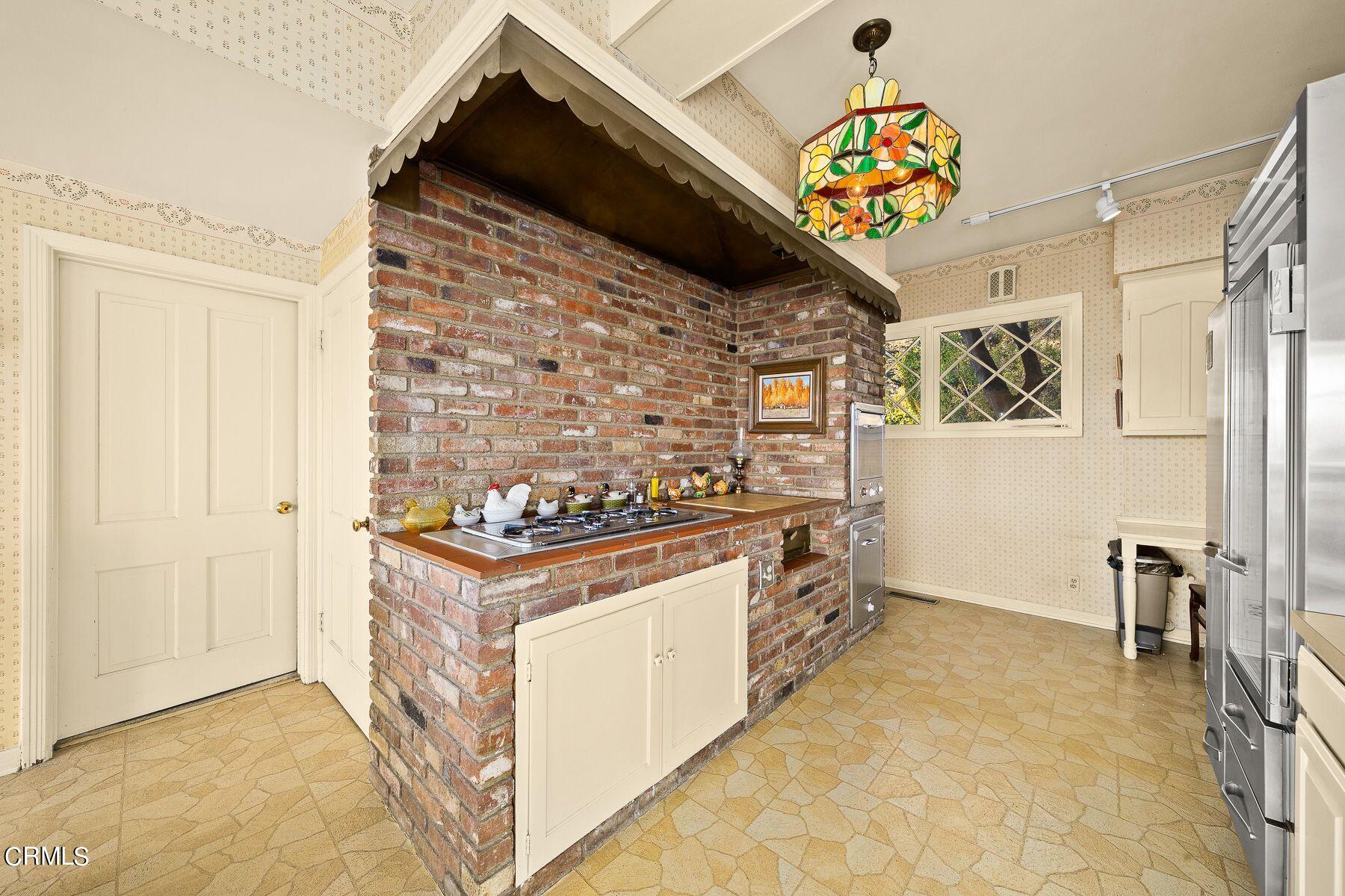 1826 Ransom Road Glendale, CA 91201 - Photo 26 of 61 a utility room with stainless steel appliances granite countertop a stove and a refrigerator