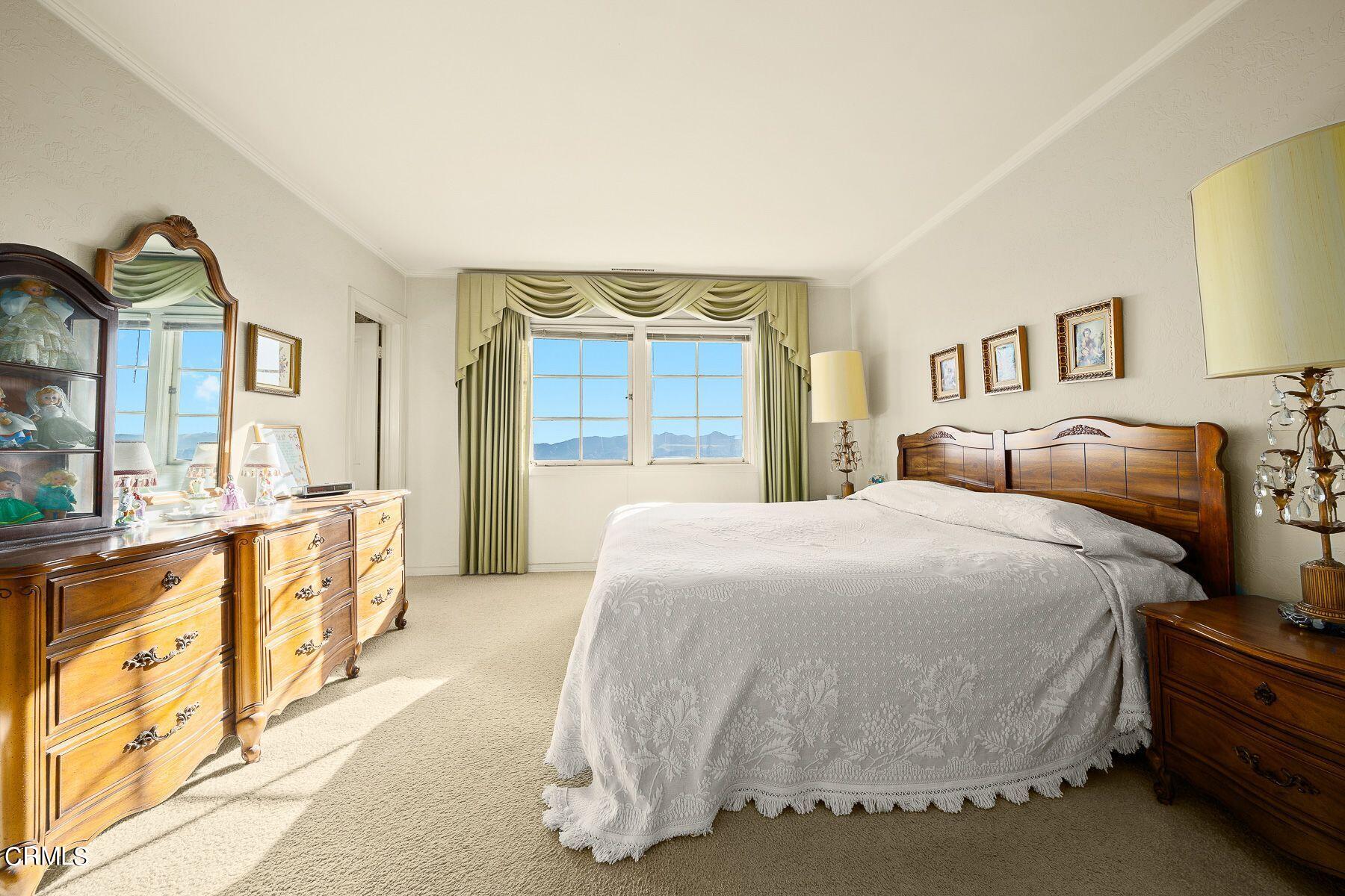 1826 Ransom Road Glendale, CA 91201 - Photo 42 of 61 a spacious bedroom with a bed and a dresser with mirror