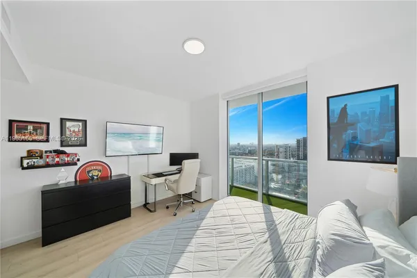 a bedroom with a bed and a desk