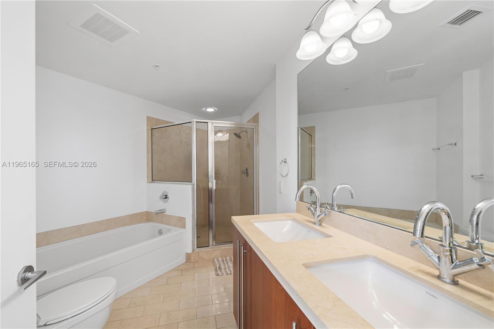 1111 Southwest 1st Avenue, Unit 2114N Miami, FL 33130 - Photo 16 of 23 a bathroom with a granite countertop sink a toilet and bathtub