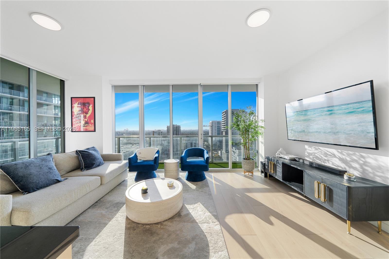 1111 Southwest 1st Avenue, Unit 2114N Miami, FL 33130 - Photo 2 of 23 a living room with fireplace furniture and a flat screen tv