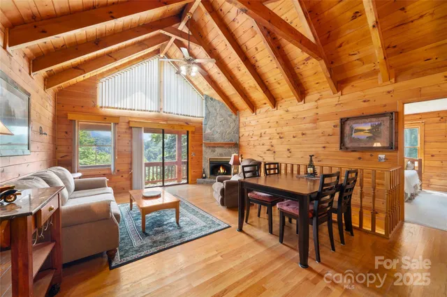 a dining room with furniture a chandelier and wooden floor