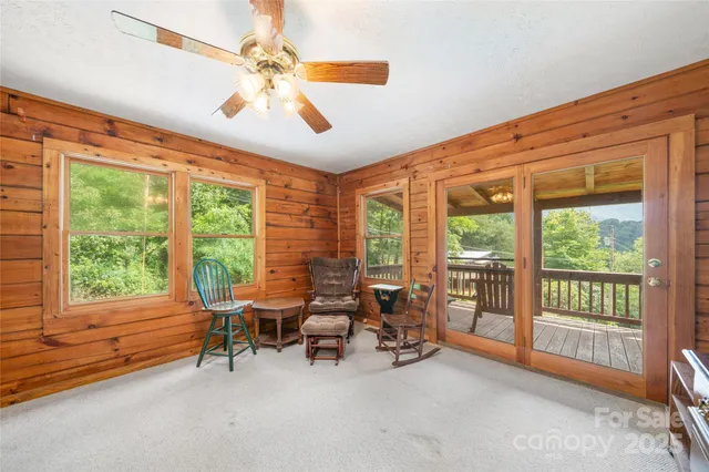 a living room with furniture and a flat screen tv with wooden floor