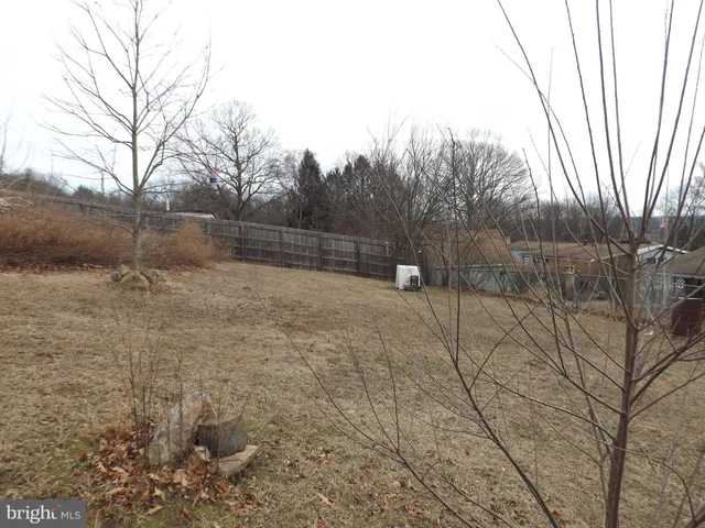 a kitchen with stainless steel appliances granite countertop a refrigerator a stove and a sink with wooden cabinets
