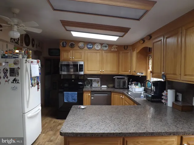 a kitchen with a window a sink and a wooden cabinets