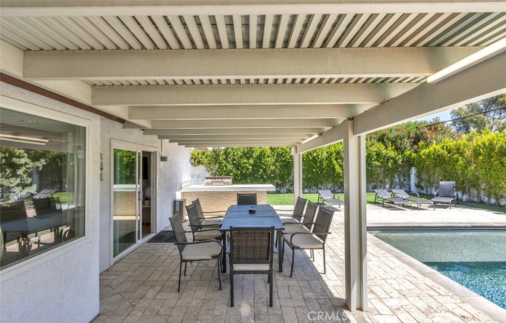 2230 North Volturno Road Palm Springs, CA 92262 - Photo 13 of 34 a view of a dining room with furniture large windows and wooden floor