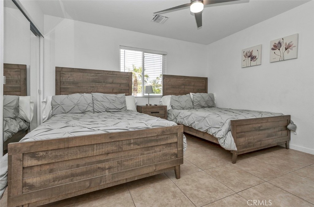 2230 North Volturno Road Palm Springs, CA 92262 - Photo 22 of 34 a bedroom with bed and a chandelier