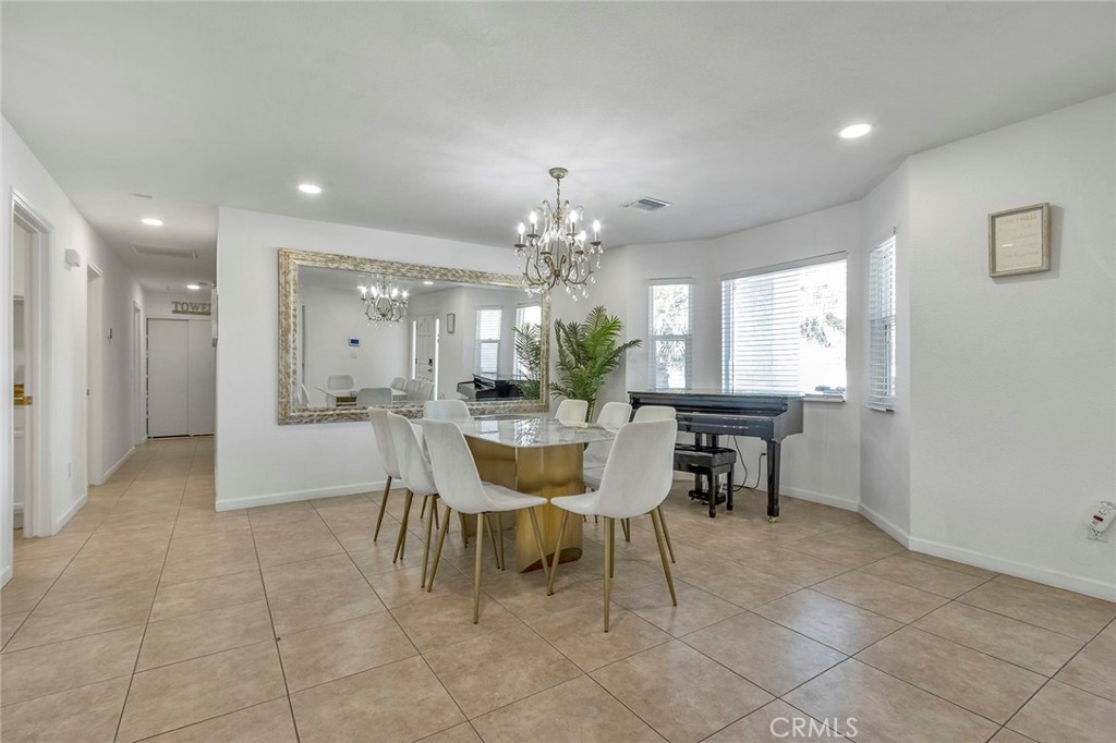 2230 North Volturno Road Palm Springs, CA 92262 - Photo 5 of 34 a dining room filled a chandelier and kitchen view