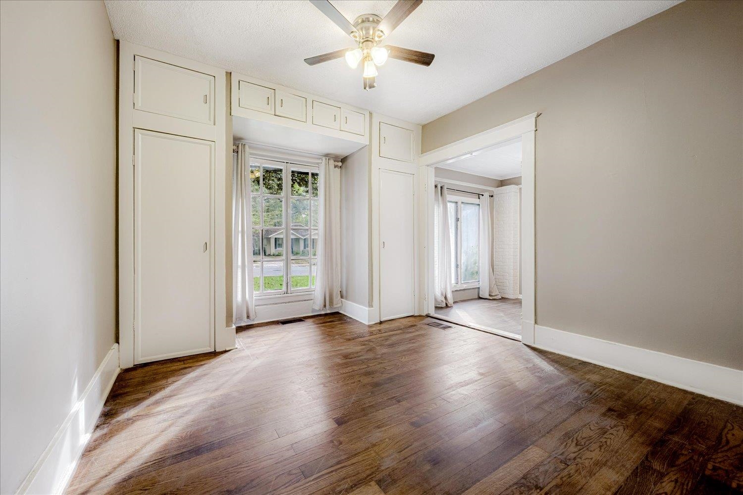 431 Alexander Street Memphis, TN 38111 - Photo 11 of 13 Empty room featuring wood finished floors, a ceiling fan, and a textured ceiling