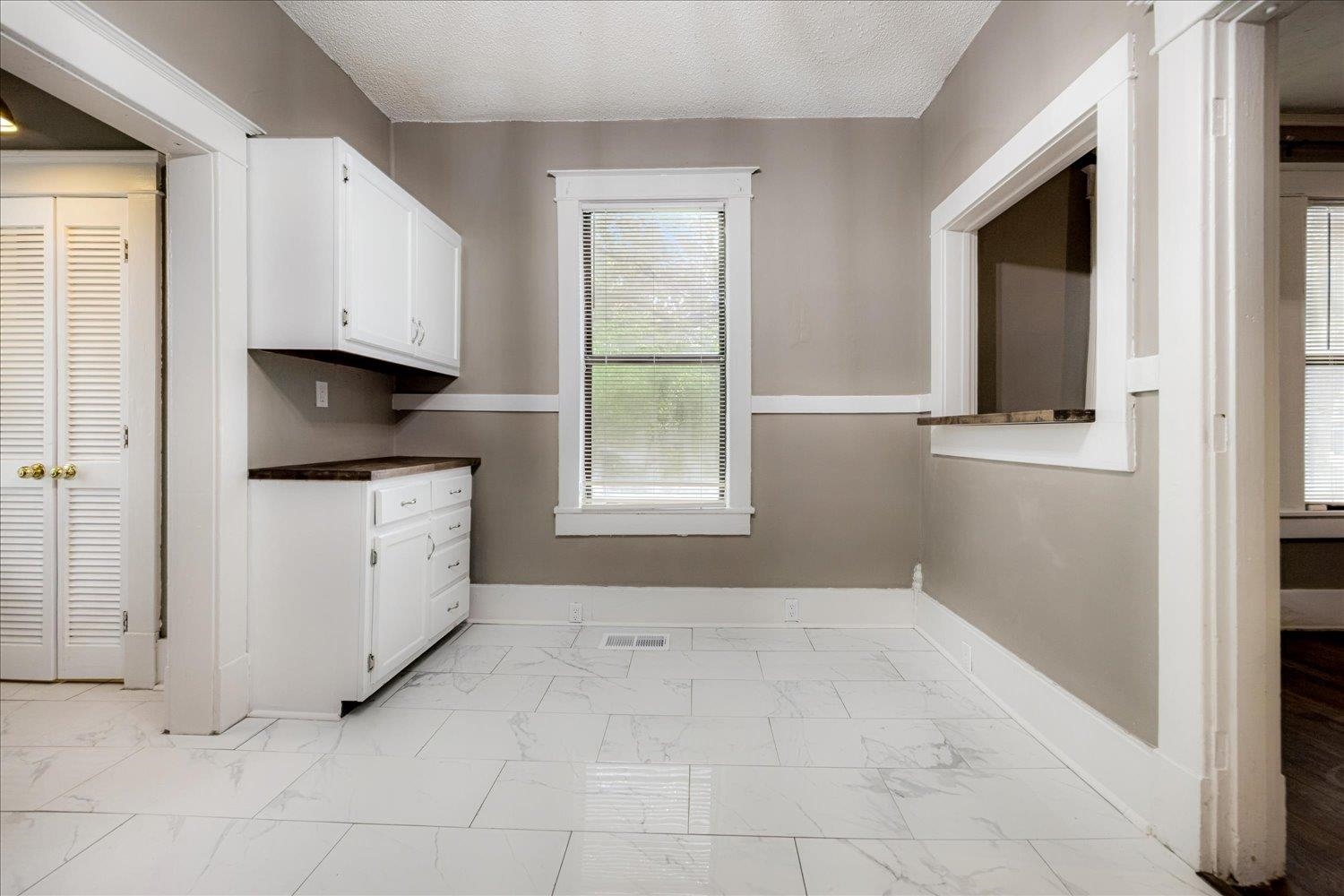 431 Alexander Street Memphis, TN 38111 - Photo 5 of 13 Laundry room featuring light marble finish floors and a textured ceiling