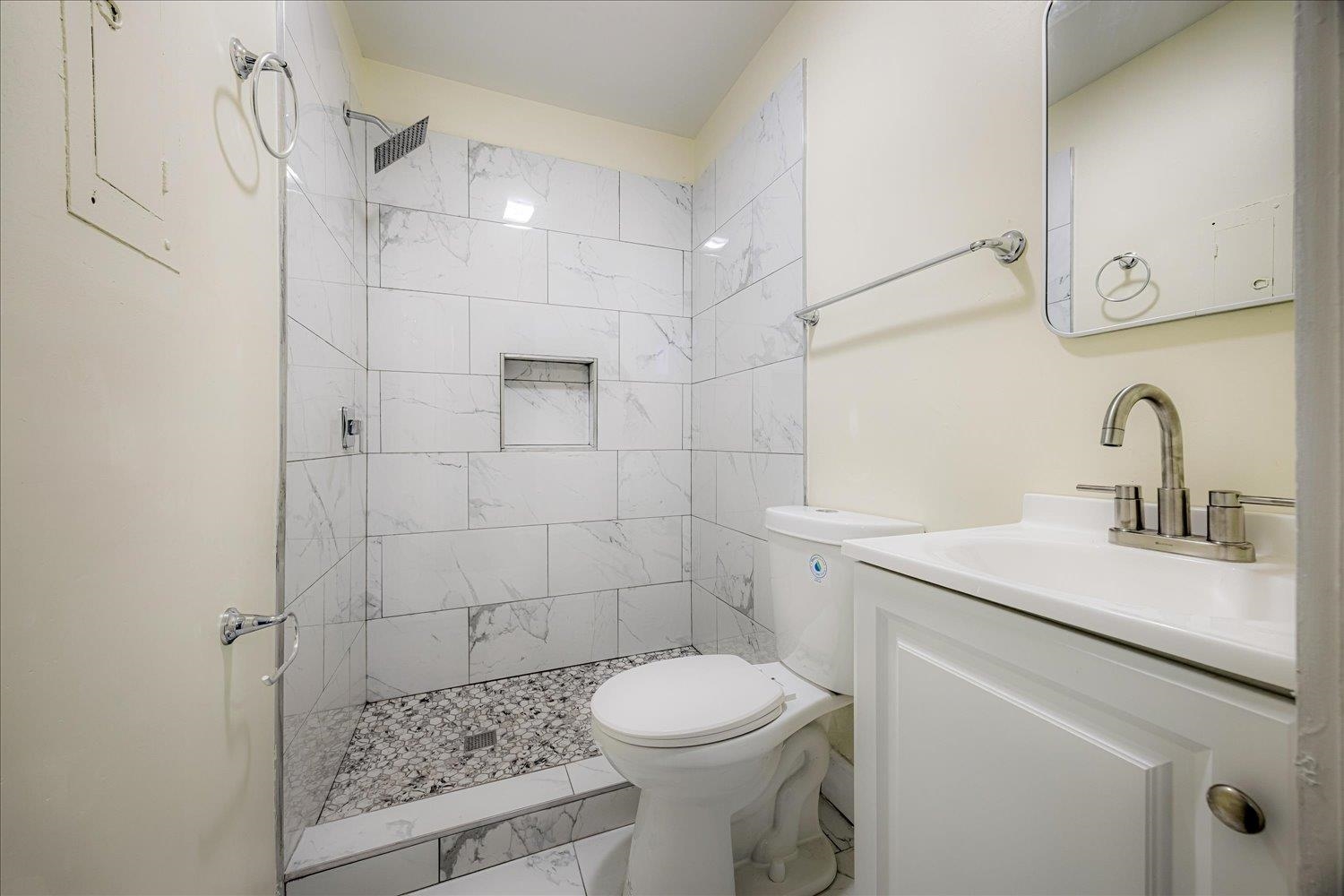 431 Alexander Street Memphis, TN 38111 - Photo 8 of 13 Bathroom with a stall shower, vanity, and marble look tiles