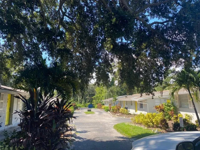 a view of a swimming pool with a patio and a yard