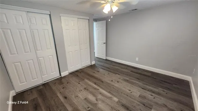 a view of a room with wooden floor